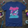 Simply JAWSOME! text with a jumping shark graphic on a royal blue t-shirt, featuring retro lightning and wave elements