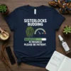 T-shirt with "Sisterlocks Budding In Progress Please Be Patient" text, featuring locs graphic and progress bar