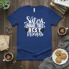 Blue t-shirt with white text that reads "Sisters Make The Best Friends" and small heart graphics