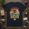 Six Seven Bruh T-Shirt with a retro sunset graphic of a grumpy cat barista making coffee