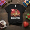 Black t-shirt with "SIX SEVEN" text and a cartoon T-Rex holding a "67" balloon, wearing a party hat