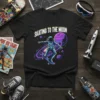 Skating to the Moon t-shirt featuring an astronaut skateboarding through space with planets and a galaxy