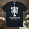Skeeltal System Human Anatomy T-Shirt featuring a white skeleton ribcage graphic and text