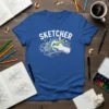 Blue t-shirt with "SKETCHER" text and a graphic of a hand drawing a city skyline with a pencil