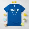 Blue t-shirt with "SMILE" text and a white smiley face graphic, primary keyword SMILE :)