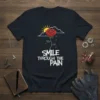Smile Through The Pain t-shirt design with a red rose, sun, clouds, and dripping water graphic