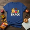SNACC text with cartoon chips, chocolate, apple, and avocado graphic on a blue t-shirt