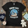 Snow Day Supporter t-shirt design featuring a yeti in a snow globe, with snowflakes and text