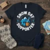 Snow Day Supporter text with mountain and hot chocolate graphic on a navy blue t-shirt