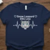 Navy t-shirt with "Snow Leopard EKG Line" text and a snow leopard face within an EKG heart rhythm graphic