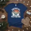 Snowcial Distancing t-shirt design with two snowmen wearing masks and keeping their distance, set against a retro sunset background