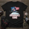 Snowmobile King t-shirt design with a rider on a snowmobile, American flag, and snowy mountain graphic