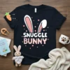 Snuggle Bunny text design with pink polka dots and striped text on a navy t-shirt, featuring white bunny ears