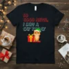 Black t-shirt with "So Good News I Saw A Cat Today" text and a cartoon cat wearing a Santa hat