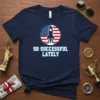 Navy blue t-shirt with white text "So Successful Lately" and a black rocket launching inside an American flag circle