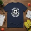 Navy t-shirt with "Soccer Coach" text and a soccer ball graphic, surrounded by a laurel wreath