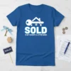 Blue t-shirt with white text "SOLD IS MY FAVORITE 4 LETTER WORD" and a graphic of a key and house