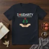 Solidarity With The Afghan People T-Shirt featuring the Afghan flag, a growing plant in hands, and supportive text