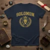 Navy t-shirt featuring the word SOLOMON in gold collegiate font above a gold lion head wearing a crown, surrounded by