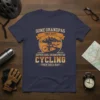 T-shirt design featuring text "Some Grandpas Take Naps Super Cool Grandpas Go Cycling (Then Take A Nap)" with a graphic