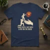 T-shirt with text "SOME PEOPLE JUST NEED A PAT ON THE BACK" featuring a graphic of one stick figure helping