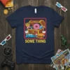 Navy t-shirt with "SOME THING" text and a cartoon treasure chest filled with junk food and a car