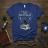 Some of us JUST DIFFERENT quote with witch cat on books graphic, celestial elements, dark green witch hat