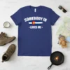 Somebody in Colorado Loves Me T-Shirt featuring the Colorado flag and white text, blue t-shirt