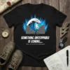 T-shirt with white text "SOMETHING UNSTOPPABLE IS COMING... Soon, the world will understand." above a graphic of a breaking wave