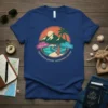 T-shirt design with "Somewhere Greener, Somewhere Warmer" text, Carolina and California signs, surf board, waves, mountains, and palm tree