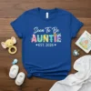 Soon To Be Auntie Est. 2026 text design on a royal blue t-shirt with floral accents