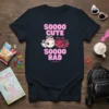 Navy t-shirt with pink text "SOOOOO CUTE SOOOOO BAD" and cartoon angel and devil characters