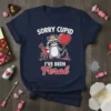 Sorry Cupid I've Been Feral t-shirt with a cool raccoon holding a heart balloon and bow and arrow