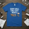 Sorry Girls, I Only Date Models text with biplane and car model graphics on a blue t-shirt