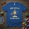 Blue t-shirt with "SORRY, GOTTA GO THE VIBES ARE OFF" text and a cartoon rocket wearing a sombrero, surrounded by