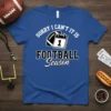 Sorry I Can't It Is Football Season text with football and calendar graphic on blue t-shirt