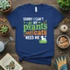 Sorry I Can't My Plants and Cats Need Me quote on a navy blue t-shirt with green plant graphics and