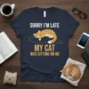 Sorry I'm Late My Cat Was Sitting On Me quote with a graphic of an orange tabby cat sleeping