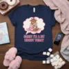 Sorry I'm A Bit Moody Today text with a cartoon cow in a bathrobe holding coffee, on a navy t-shirt