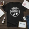 Black t-shirt with white text "SORRY I'M ON VOICE REST." featuring a microphone and speech bubble graphic