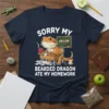 Sorry My Bearded Dragon Ate My Homework t-shirt design with a cute bearded dragon at a desk, with homework papers