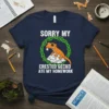 Sorry My Crested Gecko Ate My Homework t-shirt with a cartoon gecko eating paper, surrounded by vines