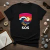 SOS t-shirt design with a stylized crashing wave, sun, and colorful sunset in a shield shape