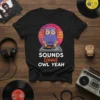 Sounds Good Owl Yeah T-Shirt featuring a purple DJ owl wearing headphones and spinning a record, with sunset graphic