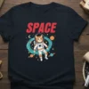 Space Cat Astronaut T-Shirt featuring a ginger cat in a white spacesuit floating among planets and stars, with the word