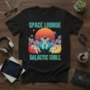 Black t-shirt with "SPACE LOUNGE GALACTIC CHILL" text and astronauts relaxing in bean bags in space, retro sunset background