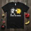 Spank The Monkey funny t-shirt design with a cartoon monkey punching a piggy bank