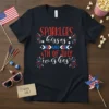 Sparklers kisses and 4th of July wishes text design on a black t-shirt, featuring red, white, and blue patriotic graphics