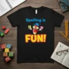 Black t-shirt with "Spelling is FUN!" text and a cartoon pencil holding letter blocks F and U