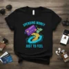 Black t-shirt with "Spending Money Just To Feel" text, featuring a credit card and falling coins in a vortex graphic